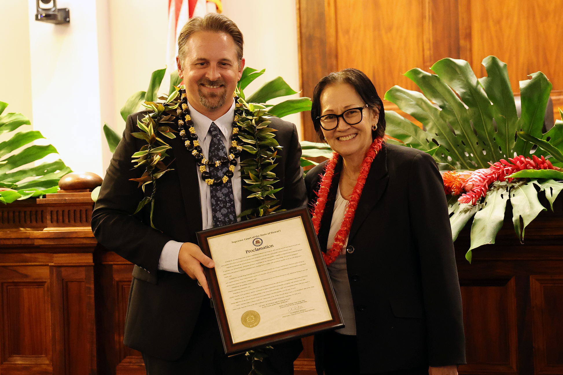 Associate Justice Sabrina S. McKenna presents Juvenile Drug Court Judge Robert J. Brown with a proclamation declaring Sept. 16 as Oʻahu Juvenile Drug Court Day.