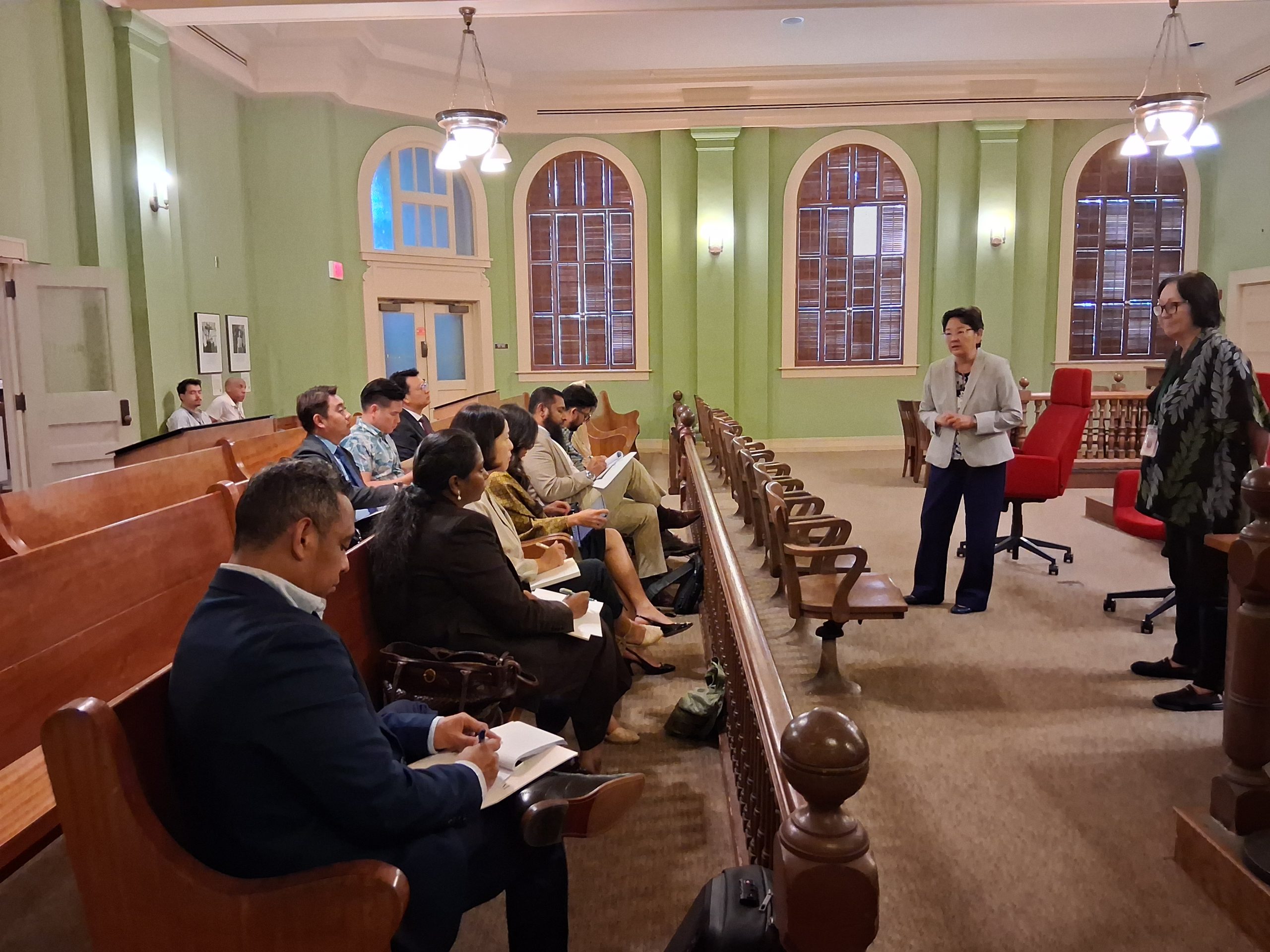 Associate Justices Sabrina S. McKenna and Lisa M. Ginoza answer questions from IVLP delegates during their visit to the 1913 Courtroom in the Supreme Court building.