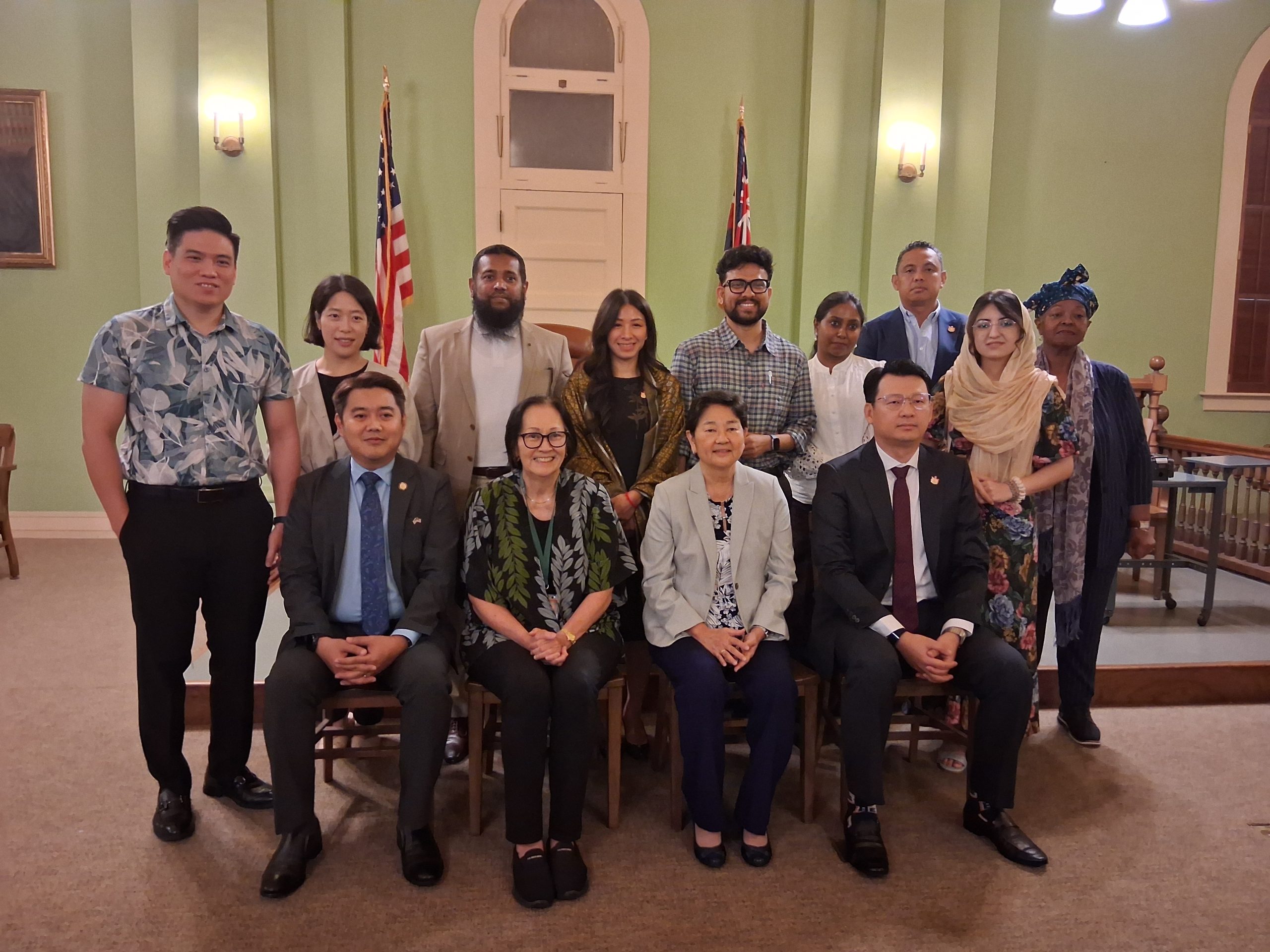 The IVLP delegation with Associate Justices Lisa M. Ginoza and Sabrina S. McKenna — 1913 Courtroom, Aliʻiōlani Hale, August 19, 2026