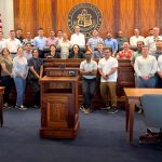 Members of the U.S. Naval War College’s Naval Command College Class of 2027 pose with Hawaiʻi Supreme Court Associate Justices Sabrina S. McKenna and Lisa M. Ginoza and Commission on Judicial Conduct Administrator Matthew McCall at Aliʻiōlani Hale.