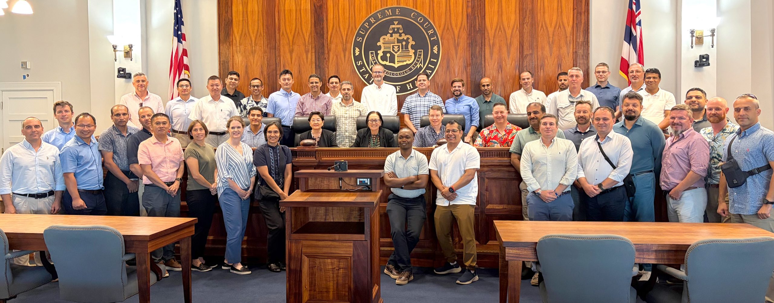 Members of the U.S. Naval War College’s Naval Command College Class of 2027 pose with Hawaiʻi Supreme Court Associate Justices Sabrina S. McKenna and Lisa M. Ginoza and Commission on Judicial Conduct Administrator Matthew McCall at Aliʻiōlani Hale.